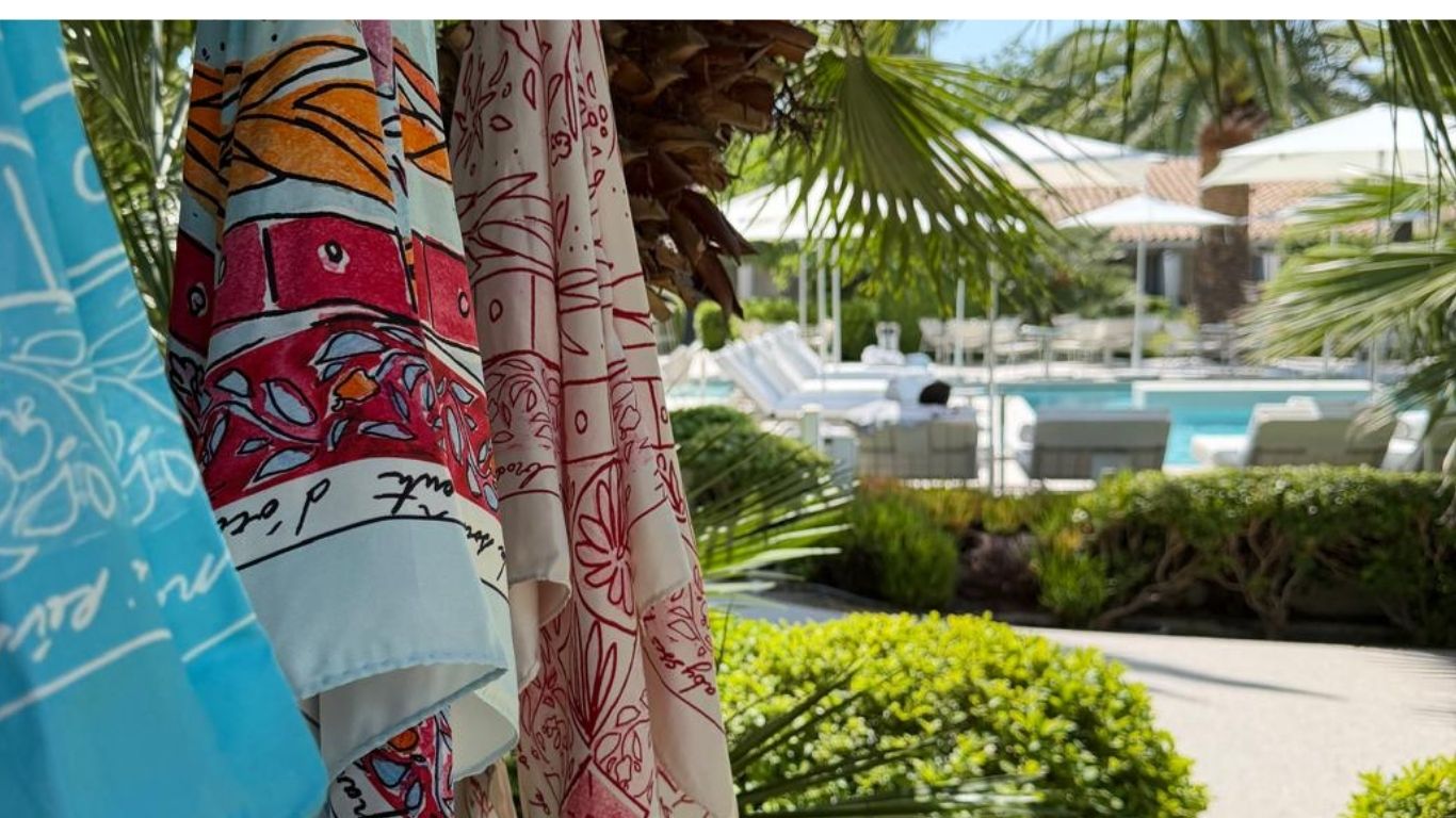 Luxury silk resortwear by Maathi at Hôtel Sezz Saint-Tropez during the Summer 2026 residency on the French Riviera, overlooking the hotel gardens and pool.